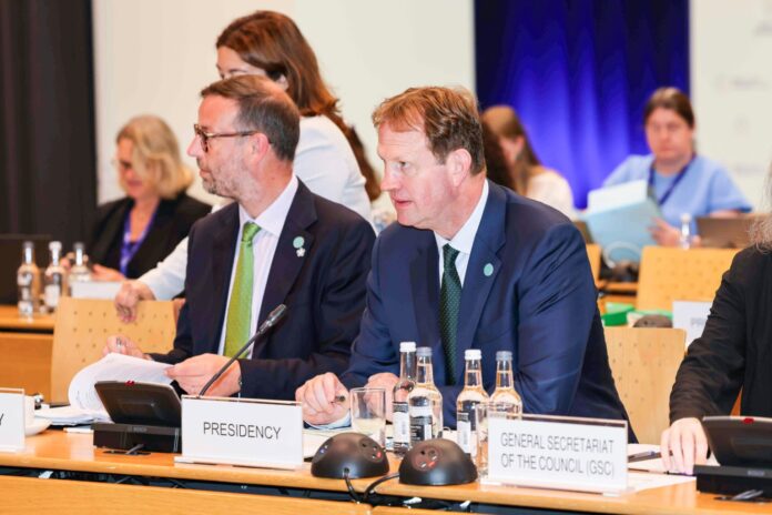 Jim O'Callaghan seated behind a Presidency nameplate at the informal meeting of EU home affairs ministers in Dublin